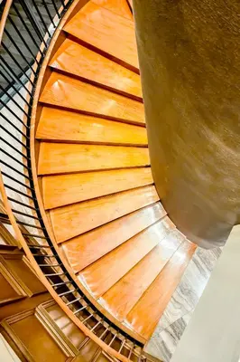 an overhead view of a wooden spiral staircase at Poblacion Stay with Pool Gym Jacuzzi and Pool Table in Manila