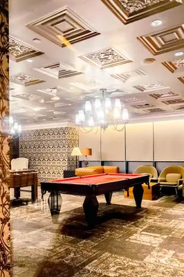 a ping pong table in a room with chairs at Poblacion Stay with Pool Gym Jacuzzi and Pool Table in Manila