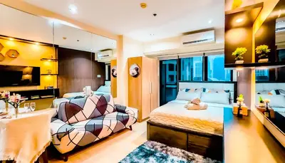 a hotel room with a bed and a couch at Poblacion Stay with Pool Gym Jacuzzi and Pool Table in Manila