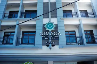 a sign on the side of a building at OYO 1168 Gimaca Boutique Hotel & Cafe in Manila