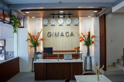 a lobby of a garma store with clocks on the wall at OYO 1168 Gimaca Boutique Hotel & Cafe in Manila