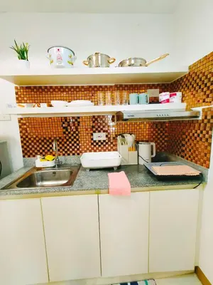 a kitchen with a sink and a counter top at Cozy 2BR Stay Near SM Southmall in Manila