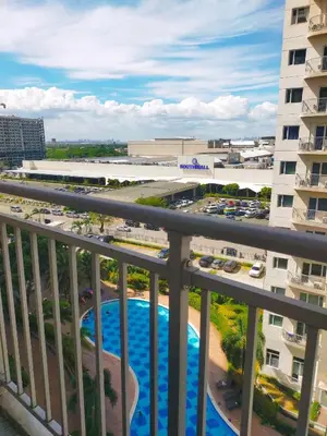 a view from a balcony of a parking lot at Cozy 2BR Stay Near SM Southmall in Manila