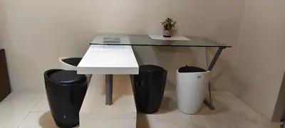 a glass table with two trash cans next to it at Cozy condy at One palm villa across NAIA T3 in Manila