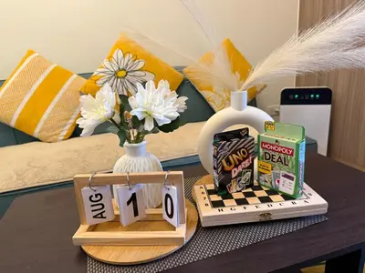 a table with a chess board and a vase with flowers at Shore 2 Tower 1 Eliel Staycation in Manila