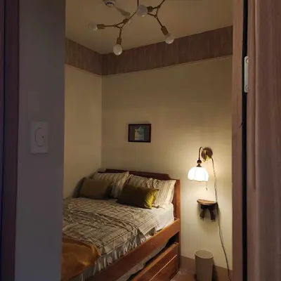 a bedroom with a bed with a lamp next to it at MOA Staycation The Baycourt at Shore Residences Near Mall of Asia IKEA NAIA SMX Convention Center MOA Concert Grounds in Manila