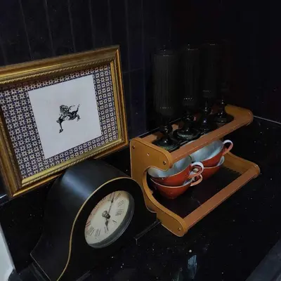 a clock sitting next to a picture and a table at MOA Staycation The Baycourt at Shore Residences Near Mall of Asia IKEA NAIA SMX Convention Center MOA Concert Grounds in Manila