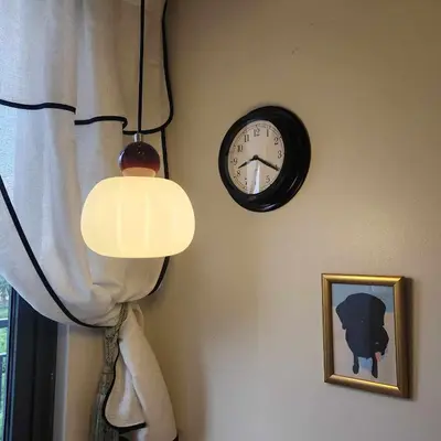 a clock hanging on a wall next to a window at MOA Staycation The Baycourt at Shore Residences Near Mall of Asia IKEA NAIA SMX Convention Center MOA Concert Grounds in Manila