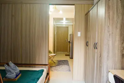 a bedroom with a bed and a door to a bathroom at Shore 2 Residences near MOA, NAIA, PITX in Manila