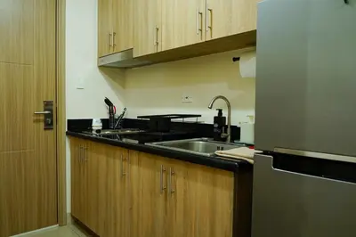 a kitchen with a sink and a counter top at Shore 2 Residences near MOA, NAIA, PITX in Manila