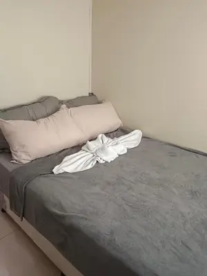 a bed with a white flower on top of it at Sea residence in Manila