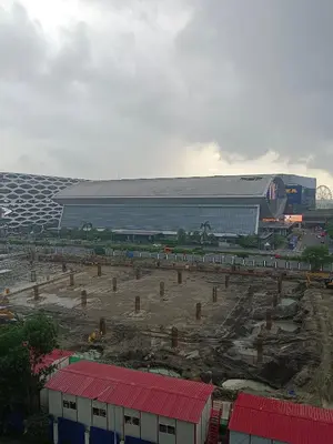 a large building with a stadium in the background at Sea residence in Manila
