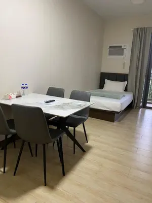 a room with a table and chairs and a bed at Bright Condo-Gentry Manor 2 mins to Okada - 6G in Manila
