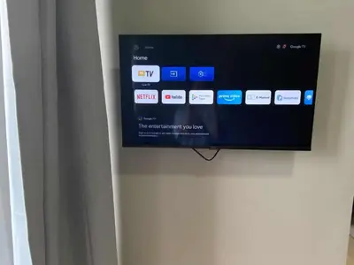 a flat screen tv hanging on a wall at Bright Condo-Gentry Manor 2 mins to Okada - 6G in Manila