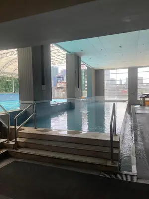 a large indoor swimming pool with water in a building at A venue Residences 2013 in Manila
