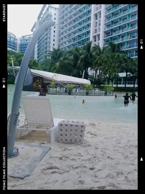 a beach with chairs and people in the water at Azure Staycationcation by Nairah in Manila