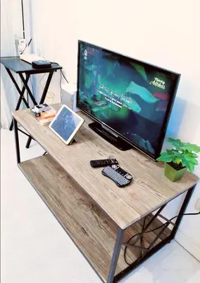 a television sitting on a table with a remote control at Azure Staycationcation by Nairah in Manila