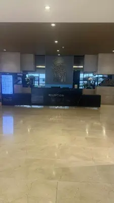 an empty lobby with a reception area in a building at Shore Residecnes Infront of MoA, Netflix, Wifi in Manila