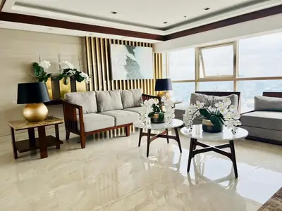 a living room with a couch and a table at Jessa Rios Coast Staycation 2 in Manila