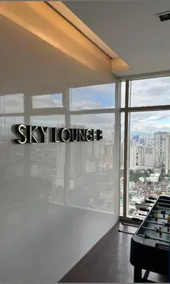 a room with the sky lounge sign on the window at Jessa Rios Coast Staycation 2 in Manila