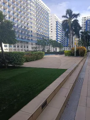 a park in front of a large building at V&G Era Staycation in Manila