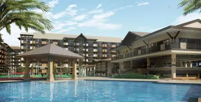 a resort with a swimming pool in front of a building at The Haru at Arista in Manila
