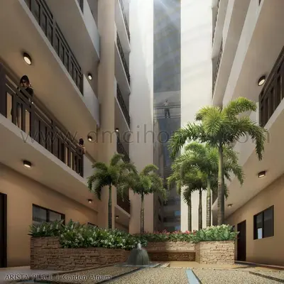 a courtyard with palm trees in a building at The Haru at Arista in Manila