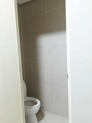 a bathroom with a toilet and a shower at WP1102 Facing pool view near MOA in Manila