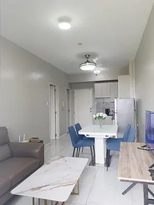 a living room with a couch and a table at WP1015 with Balcony in Manila
