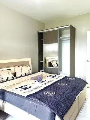 a bedroom with a large bed with a blue blanket at WP1015 with Balcony in Manila