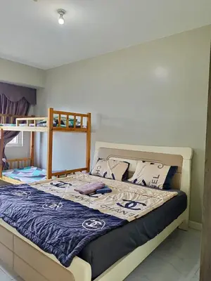 a bed in a bedroom with a bunk bed at WP1015 with Balcony in Manila