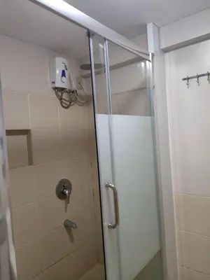 a shower with a glass door in a bathroom at Resort inspired Alea residences in Manila