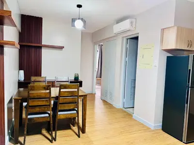 a kitchen and dining room with a table and chairs at Resort inspired Alea residences in Manila