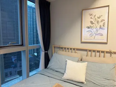 a bedroom with a bed and a large window at Bright Corner 2BR Suite with Bathtub Uptown BGC in Manila
