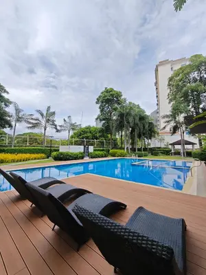 a deck with two chairs and a swimming pool at Golden Luxe Staycation Studio in Manila