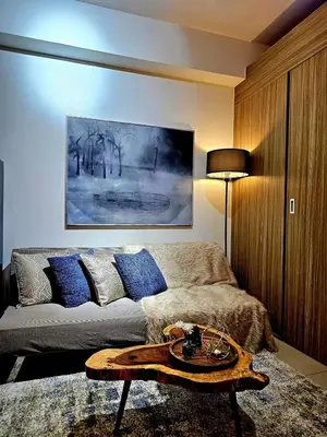 a living room with a couch and a table at Irene's luscious place in Manila