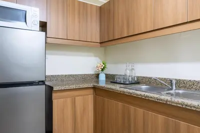a kitchen with a refrigerator and a sink at fairlane 1bed room in Manila