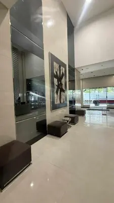a lobby with couches and a painting on the wall at Princeton condo near gilmore STA Wifi Netflex in Manila