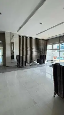 a lobby with chairs and a table in a building at Princeton condo near gilmore STA Wifi Netflex in Manila