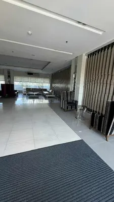 a lobby with chairs and tables in a building at Princeton condo near gilmore STA Wifi Netflex in Manila