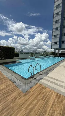 a large swimming pool with two metal handles in a building at Princeton condo near gilmore STA Wifi Netflex in Manila