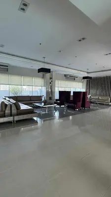 a large room with couches and chairs in a building at Princeton condo near gilmore STA Wifi Netflex in Manila