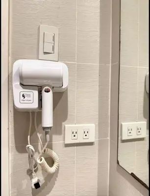 a hospital room with a phone on a wall at Nook Out at Azure Urban Residences in Manila