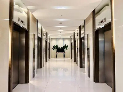a hallway of elevators in a building at Near SM MOA in Manila