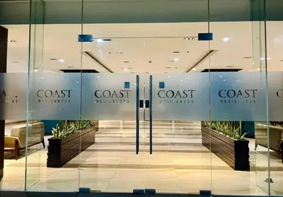 a lobby with glass walls and a coast furniture store at Near SM MOA in Manila