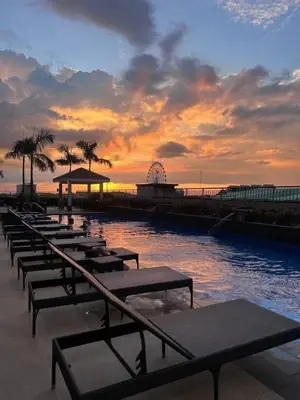 a row of chaise lounges on the beach at sunset at Near SM MOA in Manila