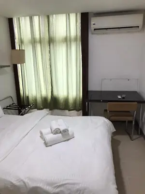 a bedroom with a bed with two towels on it at Antel Spa Residences 10B in Manila