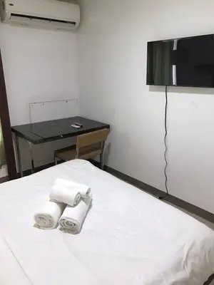 a bedroom with two towels on a bed with a table at Antel Spa Residences 10B in Manila