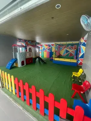 a play room with a playground and a play house at Antel Spa Residences 10B in Manila
