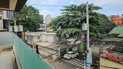 a white car parked on a street in a city at 2 Bedroom Urban Oasis Poblacion in Manila